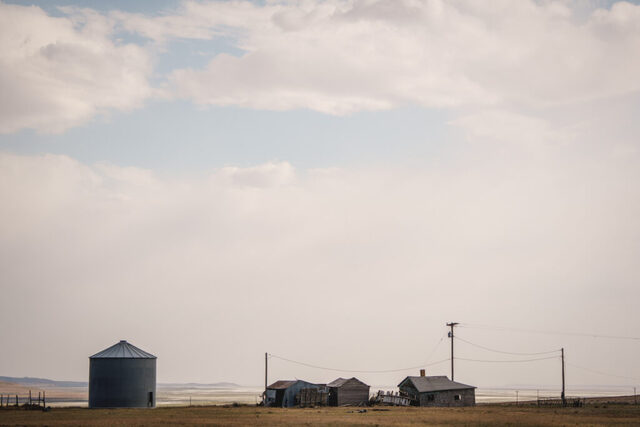 Old ranch buildings break up the horizon, with the north end of the Great Salt Lake visible in the back, in Hansel Valley, in Box Elder County, near the site of the proposed Stratos Project, a massive data center planned for 40,000 acres of land, on Wednesday, May 27, 2026. (Photo by Spenser Heaps for Utah News Dispatch)