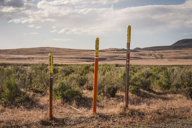 Posts warn of a buried petroleum pipeline in an area of Hansel Valley, in Box Elder County, that is part of the proposed Stratos Project, a massive data center planned for 40,000 acres of land, on Wednesday, May 27, 2026.(Photo by Spenser Heaps for Utah News Dispatch)