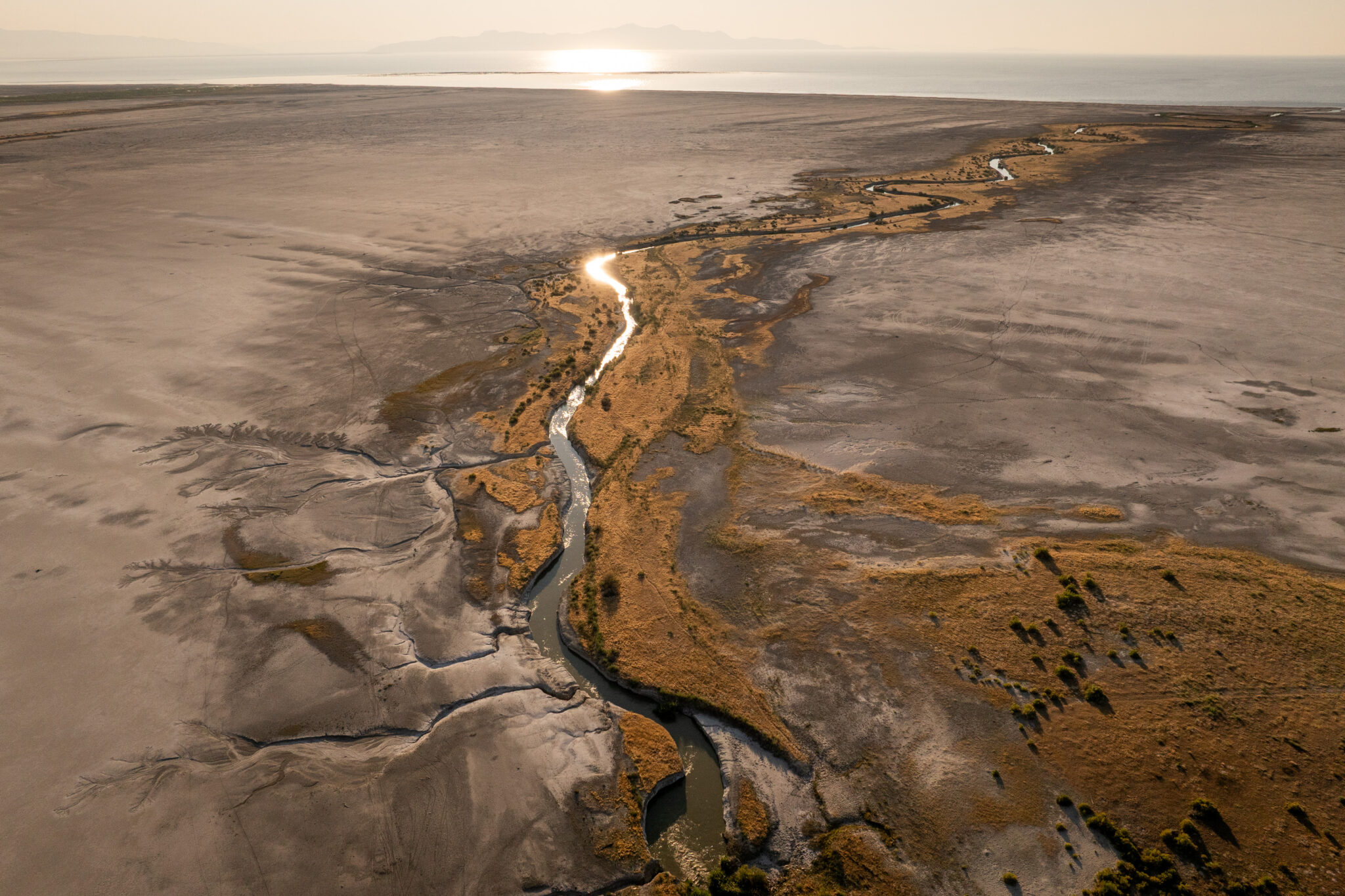 Lee Creek flows through mudflats into the Great Salt Lake near Magna on Tuesday, Aug. 5, 2025. (Photo by Spenser Heaps for Utah News Dispatch)