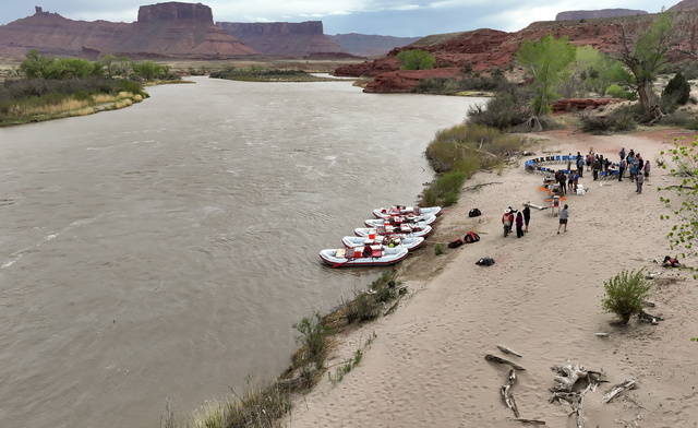 Journalists and water experts make a stop while rafting the Moab Daily section of the Colorado River with Holiday River Expeditions during a kickoff event for the Colorado River Collaborative in Grand County on Thursday, April 25, 2024. The kickoff event was sponsored by the Utah State University Janet Quinney Lawson Institute for Land, Water and Air and The Water Desk.