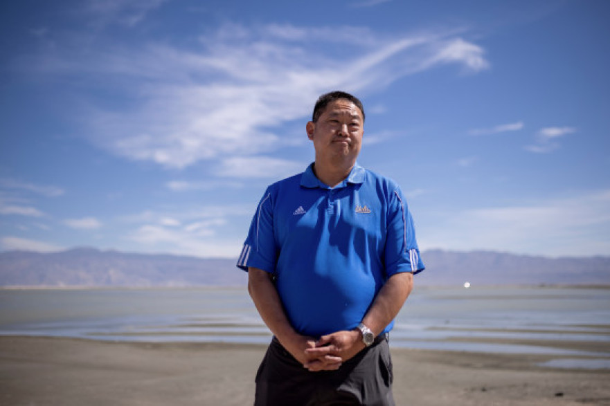 Paul Liu, manager of the Owens Lake Dust MItigation Program for the Los Angeles Department of Water and Power, talks to journalists in front of a part of the area that holds some water for dust control in Inyo County, California, on Thursday, Aug. 11, 2022.