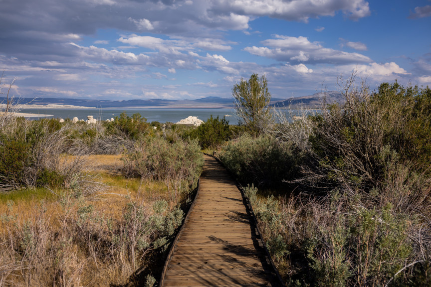 A boardwalk stretches toward the current shoreline of Mono Lake, as seen from around the location of the historic water level of Mono Lake in 1941 before water diversions by Los Angeles first began, at Mono Lake Park near Lee Vining, California, on Monday, Aug. 8, 2022.