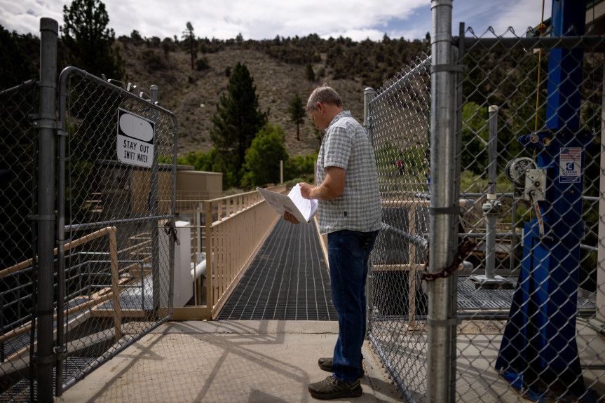 Geoffrey McQuilkin, executive director of the Mono Lake Committee, shows journalists the gates that are used to divert water from Lee Vining Creek to serve Los Angeles on Tuesday, Aug. 9, 2022.