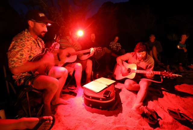 Davide Ippolito, Returning Rapids researcher and OARS river guide, Peter Lefebvre, Returning Rapids researcher and OARS river guide, and Levi Jamison, guest river guide, play music during a six day Colorado River trip through Cataract Canyon with the Returning Rapids Project on Thursday, Sept. 19, 2024.