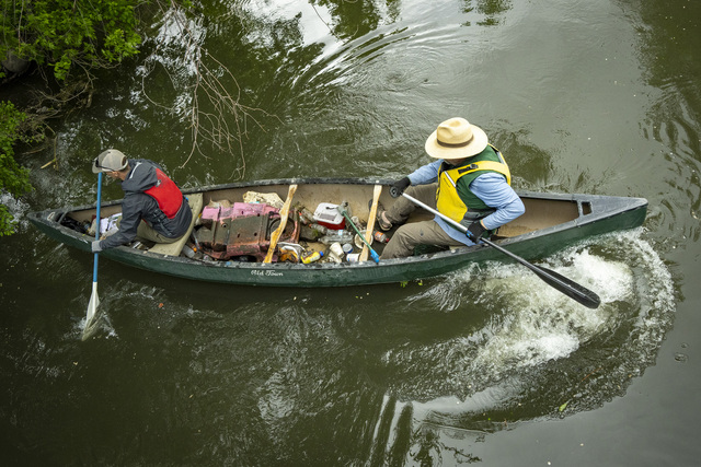 (Rick Egan | The Salt Lake Tribune) Sam Taylor and Carl Adams pick up trash along the banks of the Joran River on Wednesday, April 22, 2026, as the Jordan River Commission hosted an Earth Day kayak-based river cleanup on the Jordan River.