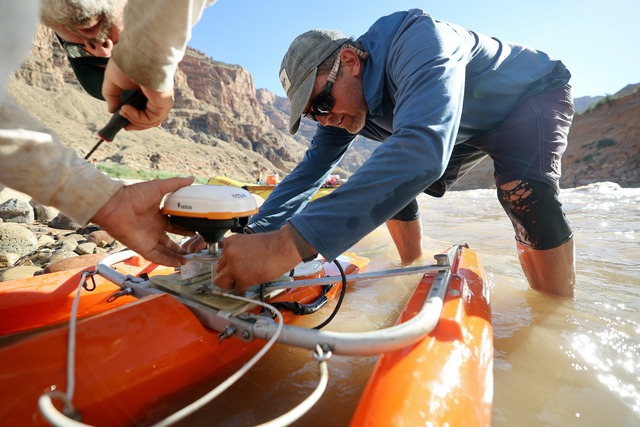 Chris Wilkowske, USGS Water Science Center supervisory hydrologist, and Mike DeHoff, Returning Rapids principal investigator, set up a sonar acoustic doppler current profiler to measure the depth and speed of water currents in the Colorado River just below Gypsum Canyon rapid in Cataract Canyon on Friday, Sept. 20, 2024.