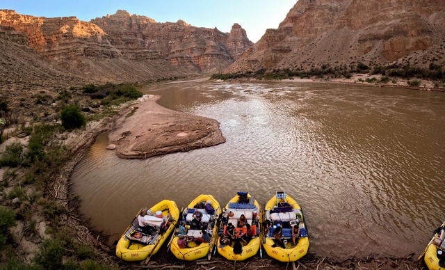 Boaters lounge on rafts near a mudbank at Lower Ten Cent campsite in Cataract Canyon on the Colorado River on Thursday, Sept. 19, 2024.