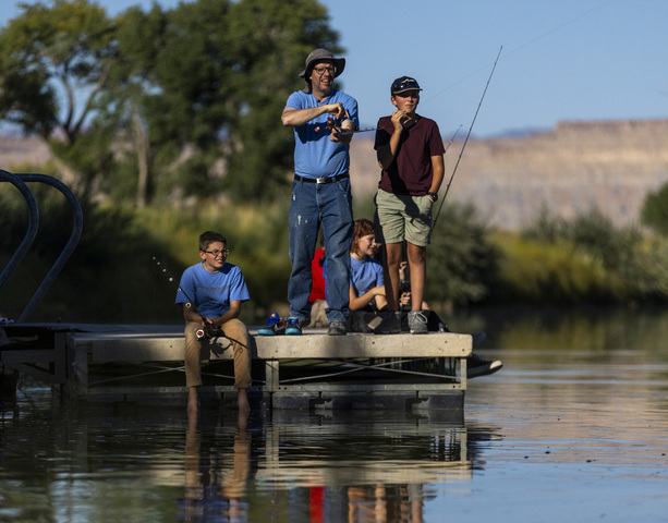 Math teacher Rob Christensen from Promontory School of Expeditionary Learning fishes with his students, Henry, 12, on the left and Lincoln, 13, on the right, on a dock in Green River State Park, a day before the 118th annual Melon Days Festival starts, in Green River on Thursday, Sept. 19, 2024.