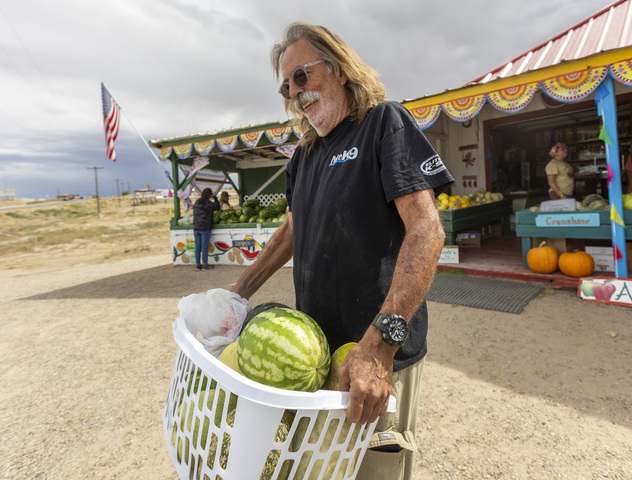 Chris Marshman, from Bullhead City, Arizona, carries a laundry basket full of recently purchased watermelons away from the Dunham’s melon stand during the 118th annual Melon Days Festival in Green River on Saturday, Sept. 21, 2024. Marshman and his wife came prepared with a laundry basket for their melon purchase.