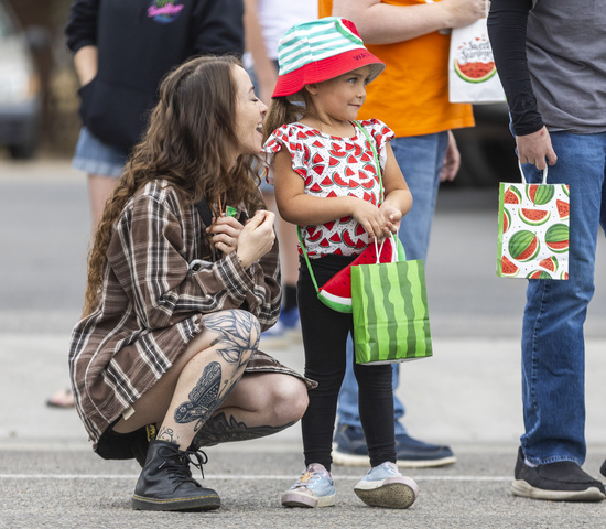 Nicole Arnold, from Salt Lake City, talks with her niece Harper Arnold, 5, from Cedar City, while Harper waits decked out in watermelon apparel for candy from the parade during the 118th annual Melon Days Festival in Green River on Saturday, Sept. 21, 2024.