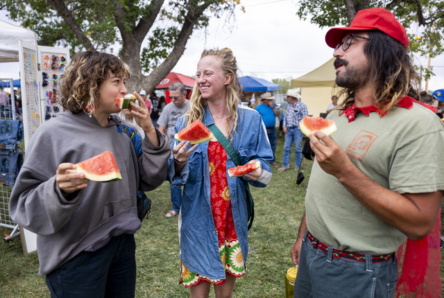 Molly Gurney, left, Eliza Van Wetter, center and Alex Veilleux, right, all from Moab, enjoy watermelon during the 118th annual Melon Days Festival in Green River on Saturday, Sept. 21, 2024.