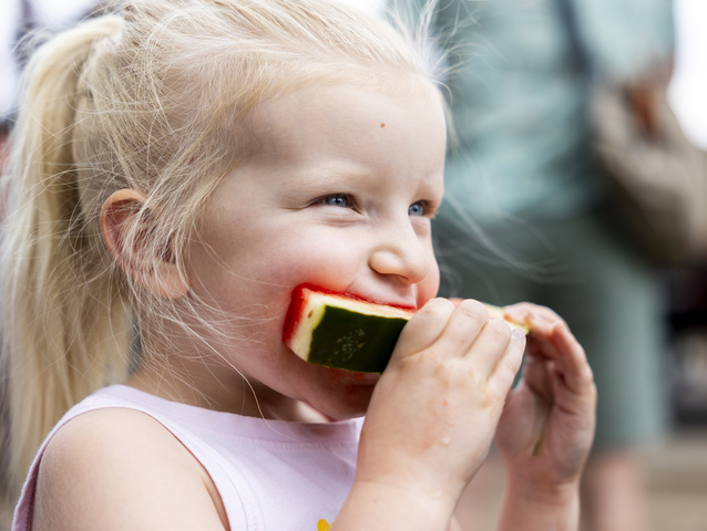 Cassidy Rubin, 3, from Moab, takes a bite of watermelon during the 118th annual Melon Days Festival in Green River on Saturday, Sept. 21, 2024.