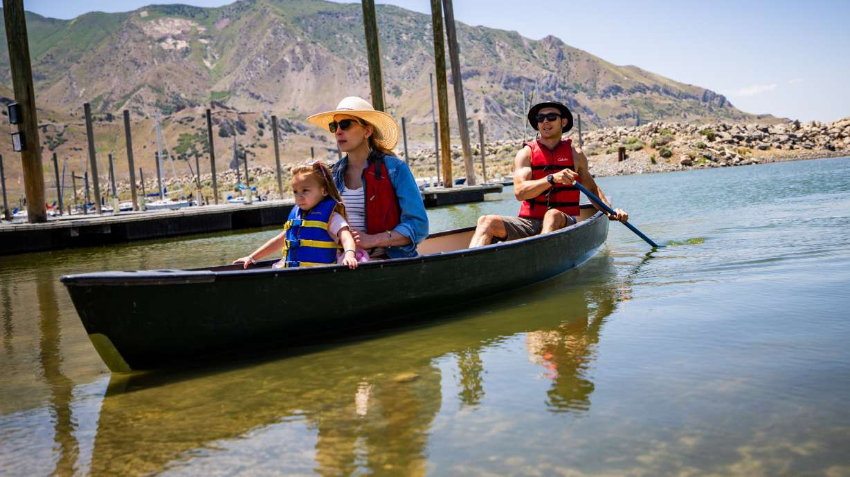 Claire and Tim Gibson and their daughter Elodie Gibson, 2, canoe at Sailfest at the Great Salt Lake on Saturday. Lake levels have already peaked this year and could fall to levels that impact future boating, experts warn. (Tess Crowley/Deseret News)