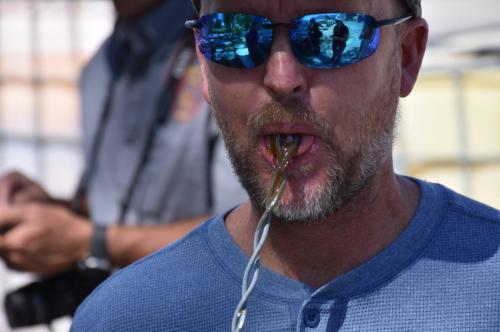 (Utah Department of Environmental Quality) A photo from an inspection done Aug. 28, 2019, shows American Chemical plant manager John M. Gustafson, licking a wire dipped into the material from an oil drum.