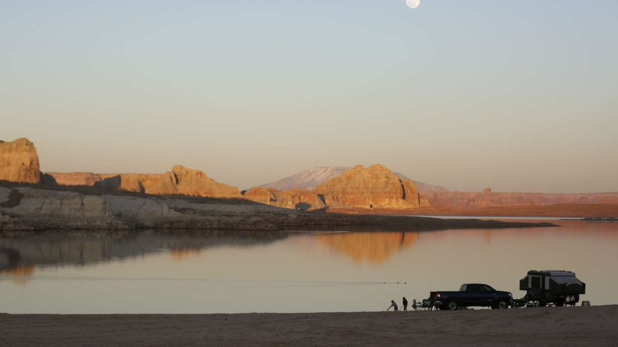 People camp on Lone Rock Beach in the Glen Canyon National Recreation Area at Lake Powell in Utah on March 27, 2021. (Kristin Murphy/Deseret News)