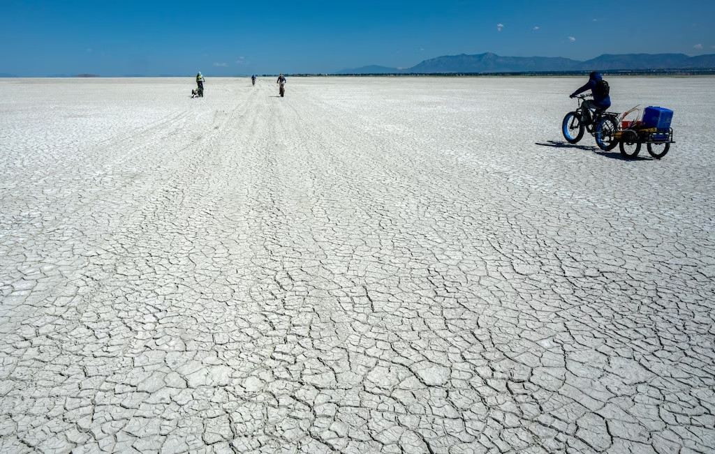 (Rick Egan | The Salt Lake Tribune) Geology professor Bill Johnson and his University of Utah graduate students haul equipment out onto the drying playa of the Great Salt Lake on Tuesday, June 17, 2025.