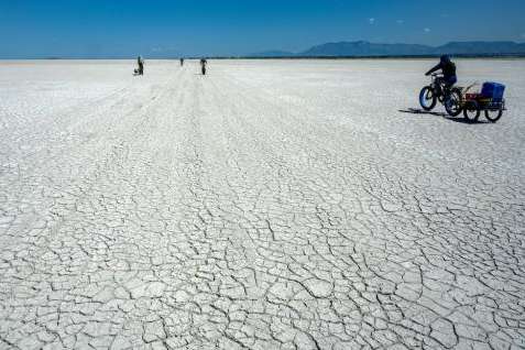(Rick Egan | The Salt Lake Tribune) Geology professor Bill Johnson and his University of Utah graduate students haul equipment out onto the drying playa of the Great Salt Lake on Tuesday, June 17, 2025.