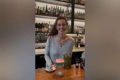 Post Office Place Bartender April Long poses with "What Remains," a Great Salt Lake-inspired cocktail she created for this year's Salt Lake Magazine Farm-to-Glass Cocktail Content (Mariah Maynes/Great Salt Lake Collaborative)