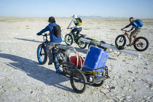 (Rick Egan | The Salt Lake Tribune) Bill Johnson's University of Utah graduate students haul their equipment out onto the playa of the Great Salt Lake on Tuesday, June 17, 2025.