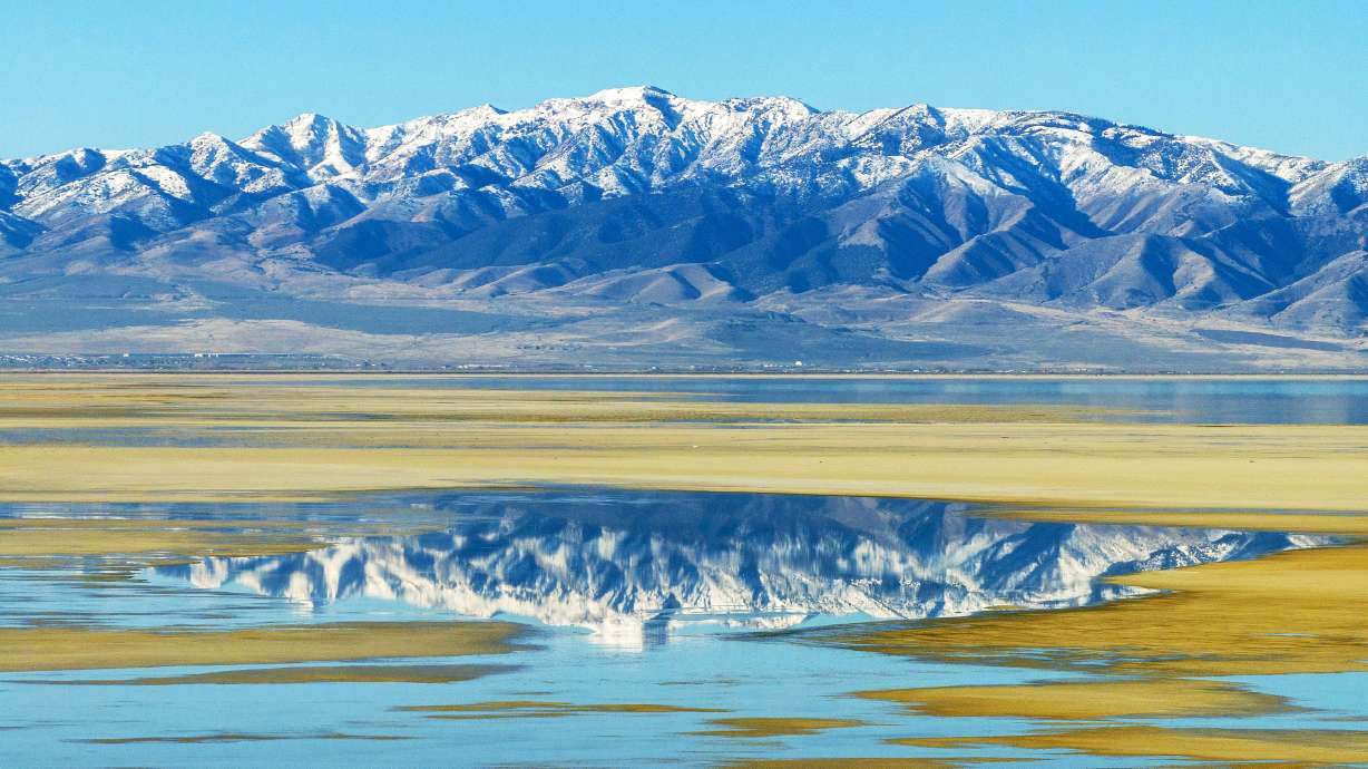 The Stansbury Mountains are reflected in a patch of water along the Great Salt Lake on Tuesday. The lake remains 6½ to 7 feet below what's considered its minimum healthy level. The Stansbury Mountains are reflected in a patch of water along the Great Salt Lake on Tuesday. The lake remains 6½ to 7 feet below what's considered its minimum healthy level. (Scott G Winterton, Deseret News) 