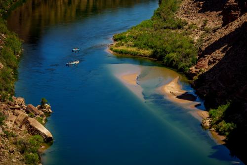 (Trent Nelson  |  The Salt Lake Tribune) Rafts on the Colorado River as seen from Navajo Bridge in Ariz. on Tuesday, May 20, 2025.