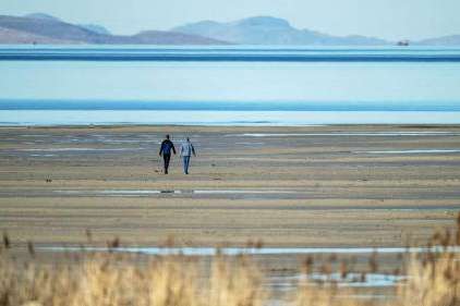 Two people walk toward the water on the sandbar at the Great Salt Lake near Magna on Jan. 6. University of Utah researchers used electromagnetic data to locate a deep freshwater reservoir beneath Farmington Bay. Two people walk toward the water on the sandbar at the Great Salt Lake near Magna on Jan. 6. University of Utah researchers used electromagnetic data to locate a deep freshwater reservoir beneath Farmington Bay. (Scott G Winterton, Deseret News)