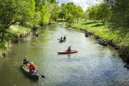 (Rick Egan | The Salt Lake Tribune) Volunteers paddle along the banks of the Jordan River on Wednesday, April 22, 2026, as the Jordan River Commission hosted an Earth Day kayak-based river cleanup on the Jordan River.
