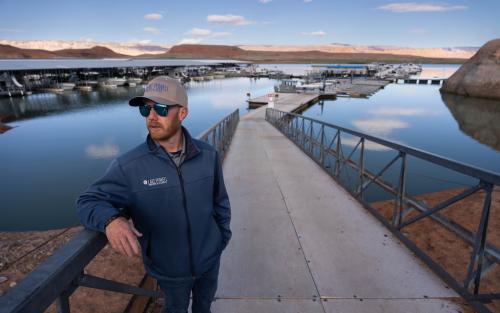 (Francisco Kjolseth | The Salt Lake Tribune) Capt. Titus Crawford, Director of Bullfrog Marina Services and Dry Storage, talks about the marina before the busy season begins around Memorial Day, Monday, April 27, 2026. Following years of water level fluctuations, the marina is scheduled to undergo it’s largest change when it is moved closer to Halls Crossing Marina in the main channel of the reservoir.