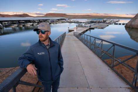 (Francisco Kjolseth | The Salt Lake Tribune) Capt. Titus Crawford, Director of Bullfrog Marina Services and Dry Storage, talks about the marina before the busy season begins around Memorial Day, Monday, April 27, 2026. Following years of water level fluctuations, the marina is scheduled to undergo it&rsquo;s largest change when it is moved closer to Halls Crossing Marina in the main channel of the reservoir.