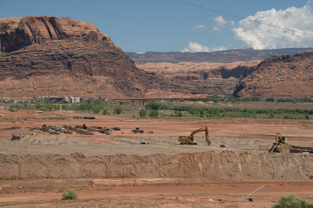 (Trevor Christensen | The Salt Lake Tribune) Construction equipment gathers radioactive mill tailings at the Utah Moab Uranium Mill Tailings Remedial Action (UMTRA) Project on Wednesday, Aug. 14, 2024. The 480-acre site was once the home of a uranium mill that processed 1,400 tons of uranium ore per day.
