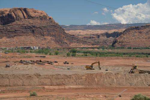 (Trevor Christensen | The Salt Lake Tribune) Construction equipment gathers radioactive mill tailings at the Utah Moab Uranium Mill Tailings Remedial Action (UMTRA) Project on Wednesday, Aug. 14, 2024. The 480-acre site was once the home of a uranium mill that processed 1,400 tons of uranium ore per day.