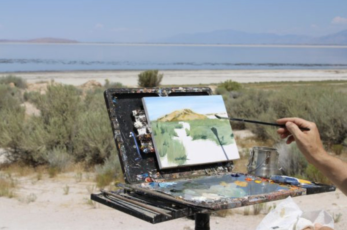 Erik Linton paints a scene from the southeastern portion of the lake near Antelope Island on July 20, 2026. (Photo by Georgia Metcalf | The Daily Utah Chronicle)