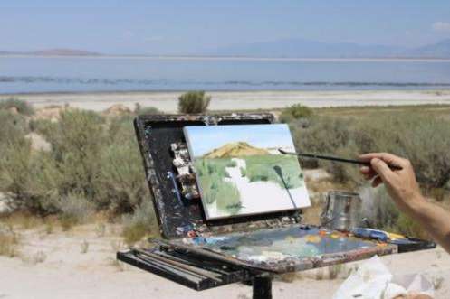 Erik Linton paints a scene from the southeastern portion of the lake near Antelope Island on July 20, 2026. (Photo by Georgia Metcalf | The Daily Utah Chronicle)