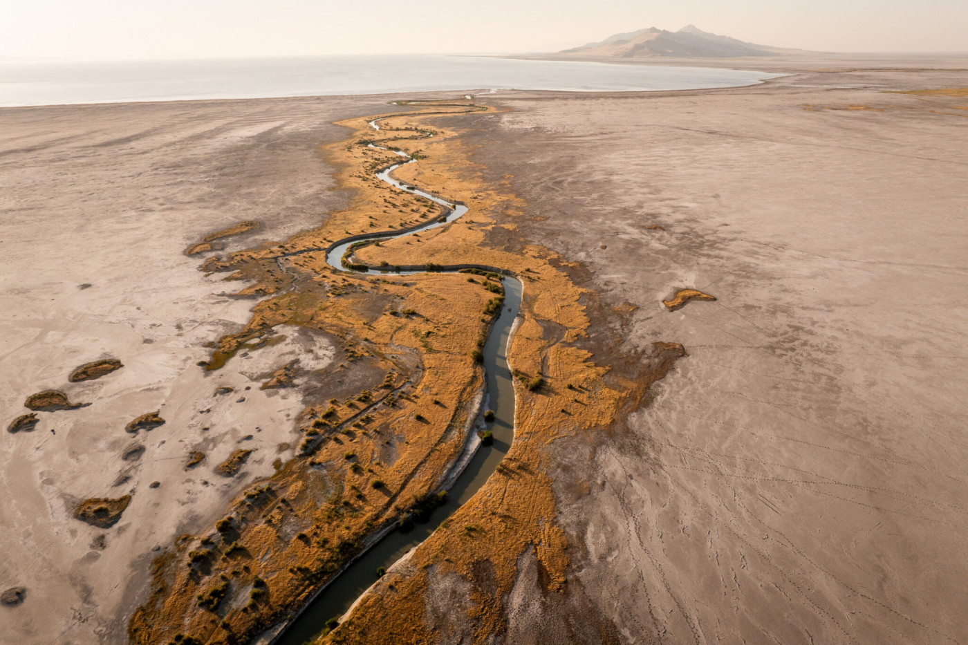 Lee Creek flows through mudflats into the Great Salt Lake near Magna on Tuesday, Aug. 5, 2025. (Photo by Spenser Heaps for Utah News Dispatch)