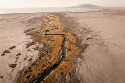 Lee Creek flows through mudflats into the Great Salt Lake near Magna on Tuesday, Aug. 5, 2025. (Photo by Spenser Heaps for Utah News Dispatch)