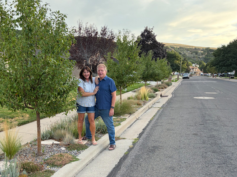 Bob and Lori Anderson stand on their park strip in South Weber. The couple replaced the grass with drought-tolerant plants in an effort to conserve water. (Photo by Cindi Mansell)