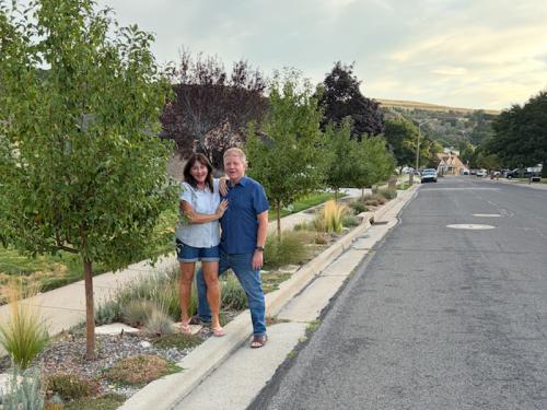 Bob and Lori Anderson stand on their park strip in South Weber. The couple replaced the grass with drought-tolerant plants in an effort to conserve water. (Photo by Cindi Mansell)