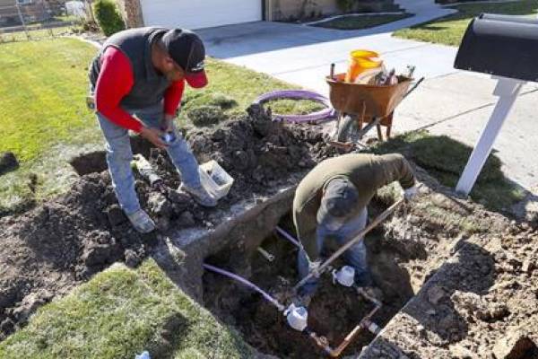Ormond Construction crews install secondary water meters in a subdivision in Woods Cross for the Weber Basin Water Conservancy District on Thursday, Nov. 7, 2019. Only 15% of secondary water connections in Utah are metered, which means that a small group of users can tell how much of the finite resource they are using and also find out how they compare to their neighbors. (Steve Griffin/Deseret News)