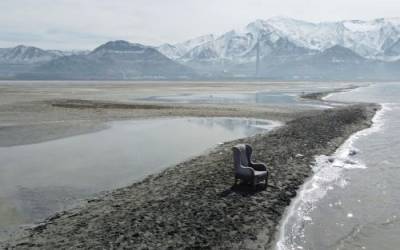 Rick Bowmer / AP A chair sits on an exposed sand bar on the southern shore of the Great Salt Lake on March 3, 2022, near Salt Lake City. The Great Salt Lake has hit a new historic low for the second time in less than a year. Utah Department of Natural Resources said Monday, June 5, 2022, in a news release, the lake dipped Sunday to 4,190.1 feet.