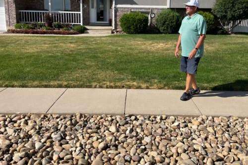 Washington Terrace Mayor Mark Allen stands outside his home on Tuesday, July 12, 2022, in front of the park strip that he converted from grass to rocks. He tapped into the Weber Basin Water Conservancy District's Flip Your Strip program to complete the changeover, meant to help reduce the amount of water he uses for irrigation.