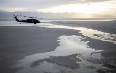 (Scott G Winterton | Pool) A Black Hawk helicopter flies over the Great Salt Lake as Utah lawmakers take an aerial tour of the Great Salt Lake with the Utah National Guard on Tuesday, Feb. 15, 2022.