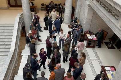 Photo by: Ben Winslow, FOX 13 News  Members of Save Our Great Salt Lake talk to lawmakers outside the House chamber.