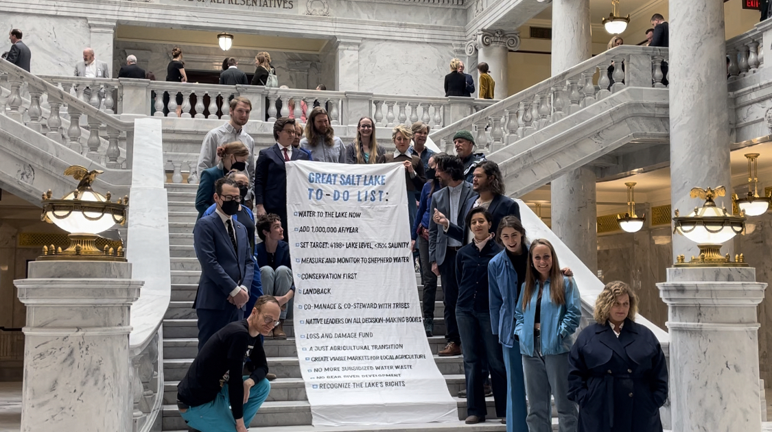 Members of Save our Great Salt Lake pose for a picture with their “Great Salt Lake To-Do List” banner outside the House chamber Wednesday, March 1, 2023. (Photo by Emma Keddington) 