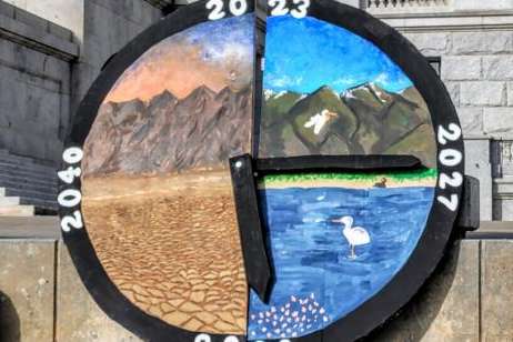 A large wooden clock depicting Great Salt Lake's demise was a central art piece at a rally Nov. 11, 2023. Aimee Van Tatenhove, UPR