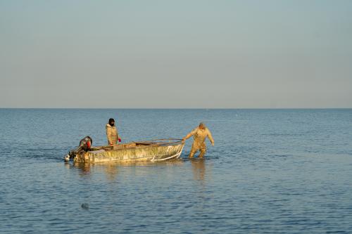 Fishermen drag a boat through the shallow waters of the Aral Sea in western Kazakhstan to a point where the water becomes deep enough to start the engines. Abduaziz Madyarov / Special For The Great Salt Lake Collaborative