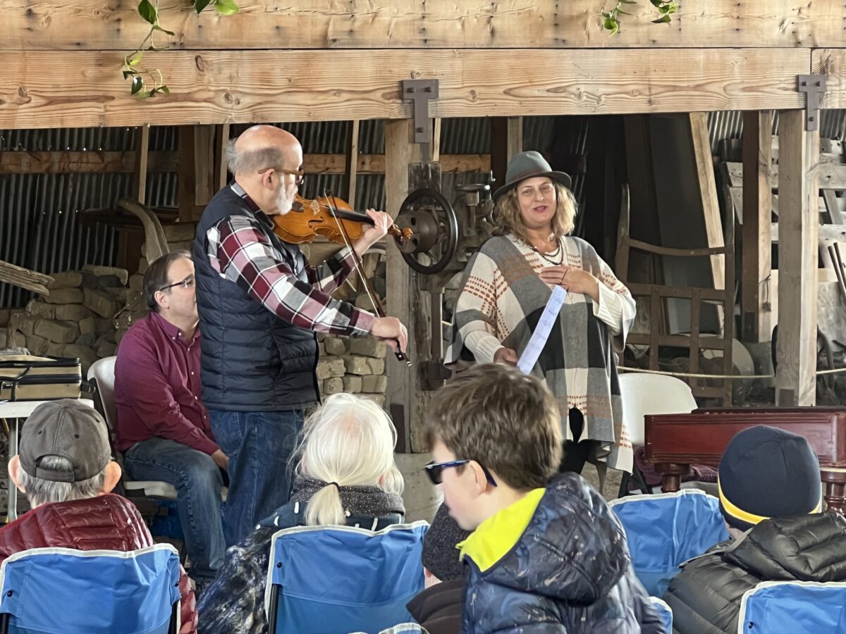 Gerald Elias plays the violin while Nan Seymour recites a poem during a gratitude concert at Antelope Island's Fielding Garr Ranch on Friday, March 15, 2024. Ryan Aston, Standard-Examiner.