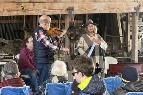 Gerald Elias plays the violin while Nan Seymour recites a poem during a gratitude concert at Antelope Island's Fielding Garr Ranch on Friday, March 15, 2024. Ryan Aston, Standard-Examiner.