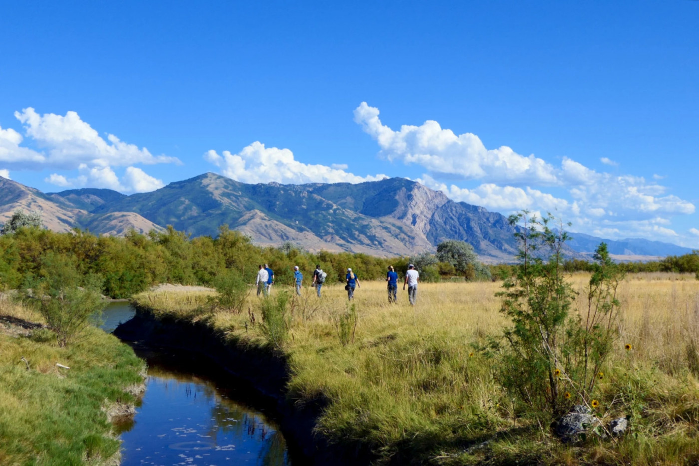 Joel Ferry leads the Great Salt Lake Commissioner’s office, including Brian Steed, as well as members of the media through his farm to look at Bear River. (Erin Lewis, UPR)