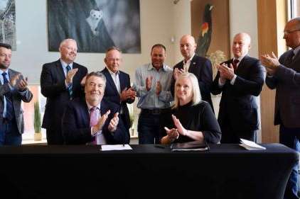 Compass Minerals CEO Edward Dowling, front left, and Utah Forestry, Fire and State Lands Director Jamie Barnes, front right, as well as Utah leaders applaud after a water conservation deal is finalized on Tuesday. The deal includes over 200,000 acre-feet directed to the Great Salt Lake every year, according to the state. (Kristin Murphy, Deseret News)