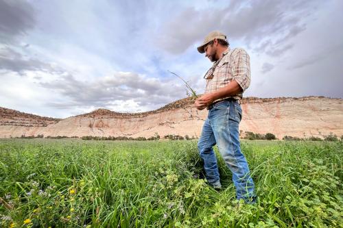 Andy Rice holds one of the nozzles on a center pivot irrigation system his ranch was able to install thanks to state money, Aug. 21, 2024. Utah’s Agricultural Water Optimization Program has put millions of dollars into helping farmers and ranchers modernize their irrigation systems since 2019. Credit: David Condos, KUER